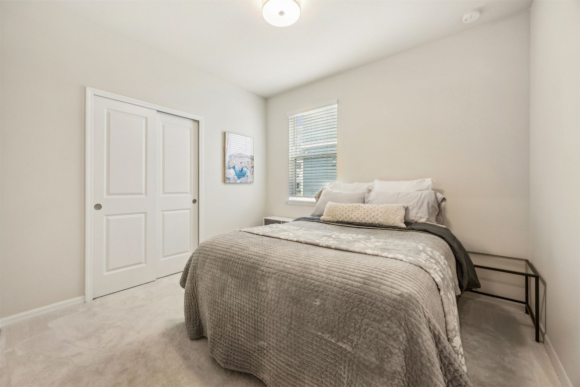 368 Muhly Grass Street Yulee, FL 32097 - Photo 25 of 60 a bedroom with a bed and a window