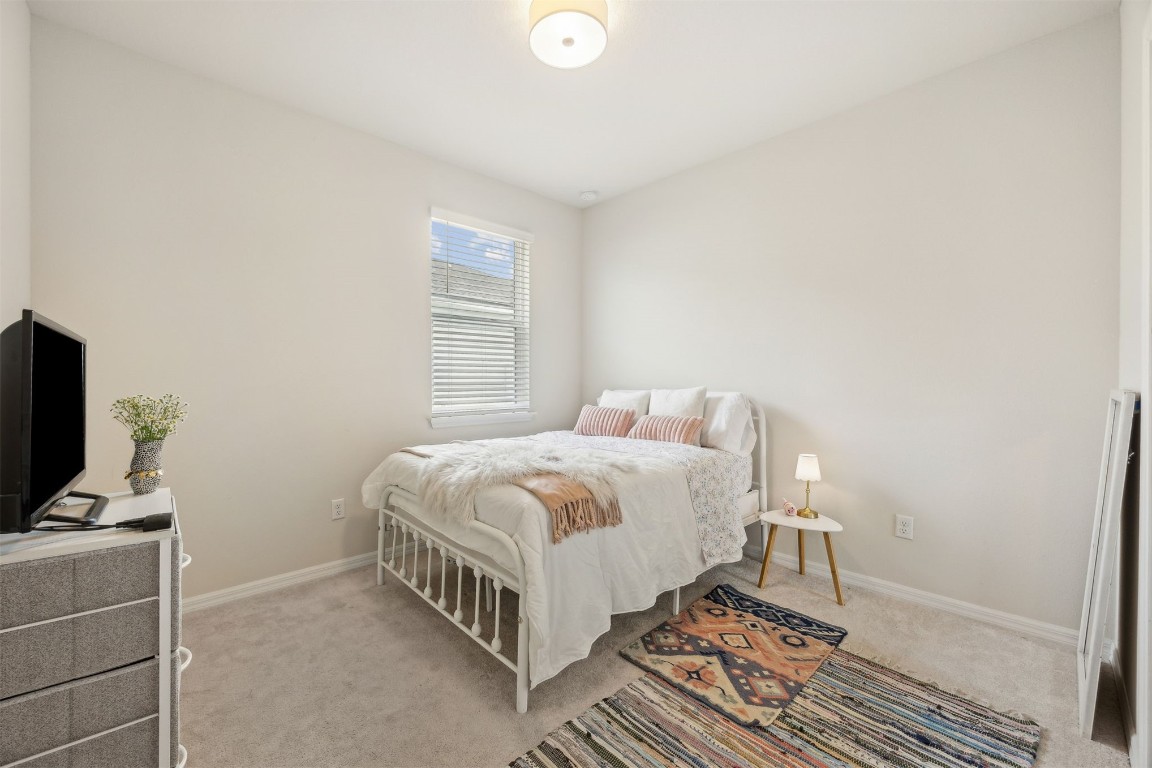 368 Muhly Grass Street Yulee, FL 32097 - Photo 26 of 60 a bedroom with a bed and a flat screen tv