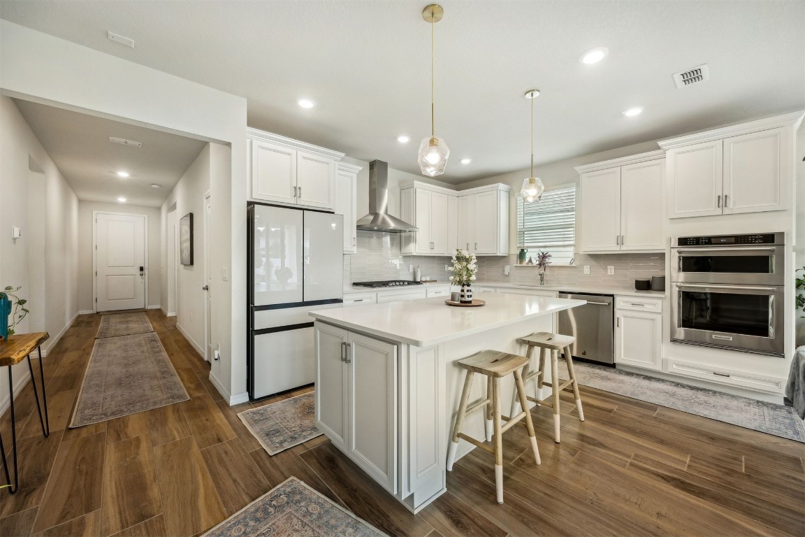 368 Muhly Grass Street Yulee, FL 32097 - Photo 7 of 60 a kitchen with stainless steel appliances kitchen island granite countertop a stove a sink and a refrigerator