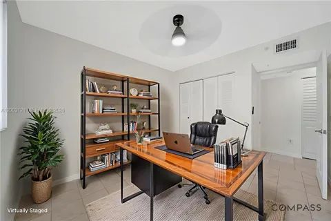 a work room with furniture and a potted plant