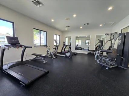 a room with gym equipment and a large window