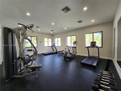 a view of a room with gym equipment and a large window