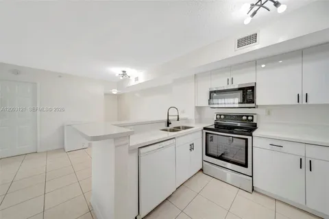 a kitchen with stainless steel appliances granite countertop a sink and cabinets