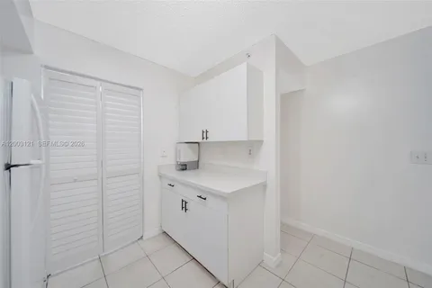 a kitchen with a sink cabinets and a window