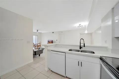 a kitchen with sink and cabinets