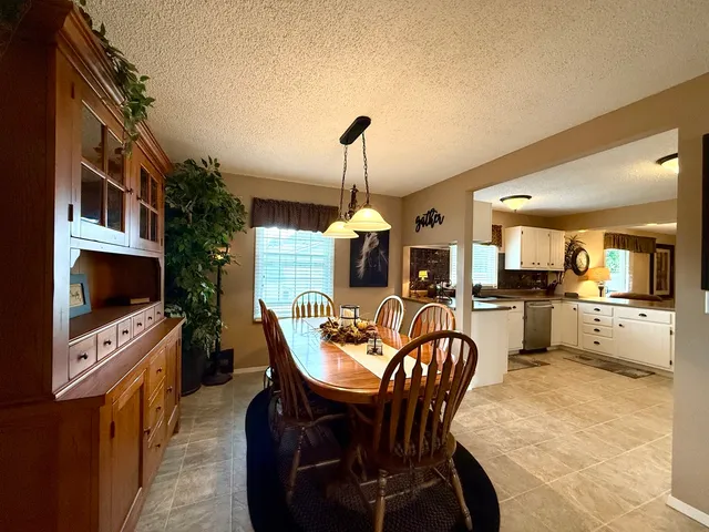 a dining room with furniture and a flat screen tv