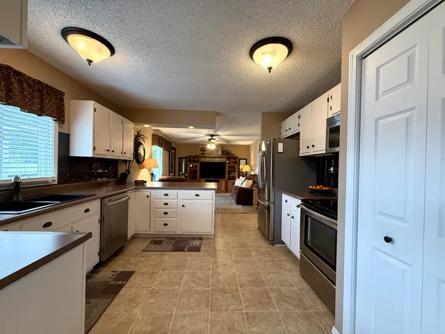 a kitchen with cabinets and window