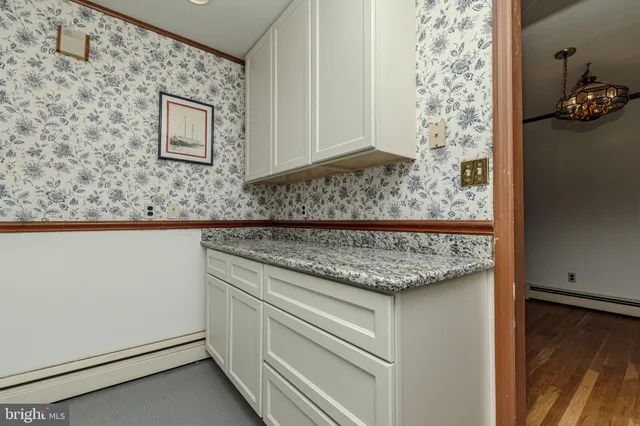 a kitchen with granite countertop a sink stainless steel appliances and cabinets
