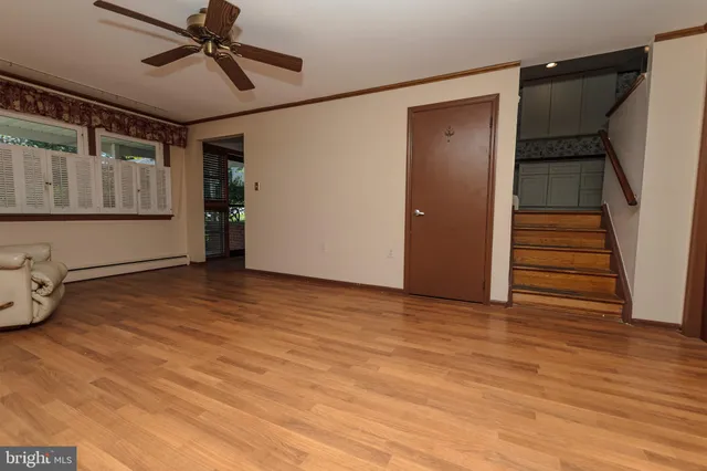 a view of an empty room with wooden floor