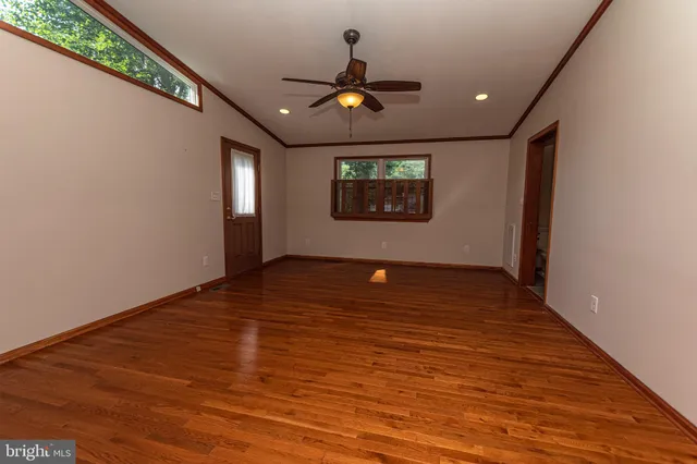 a view of walk in closet with empty racks