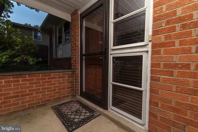 a view of a hallway with wooden floor and entryway