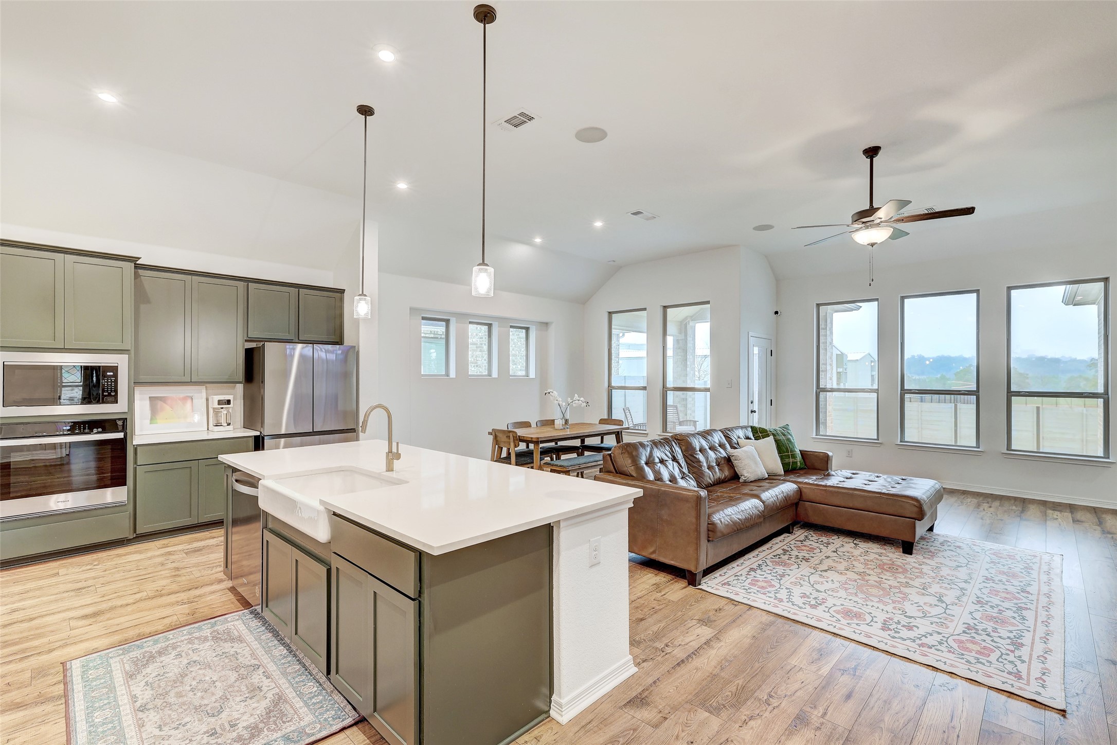 1117 Spring Gulch Lane Georgetown, TX 78628 - Photo 13 of 39 An open concept living area showcases a sleek kitchen island and abundant natural light.