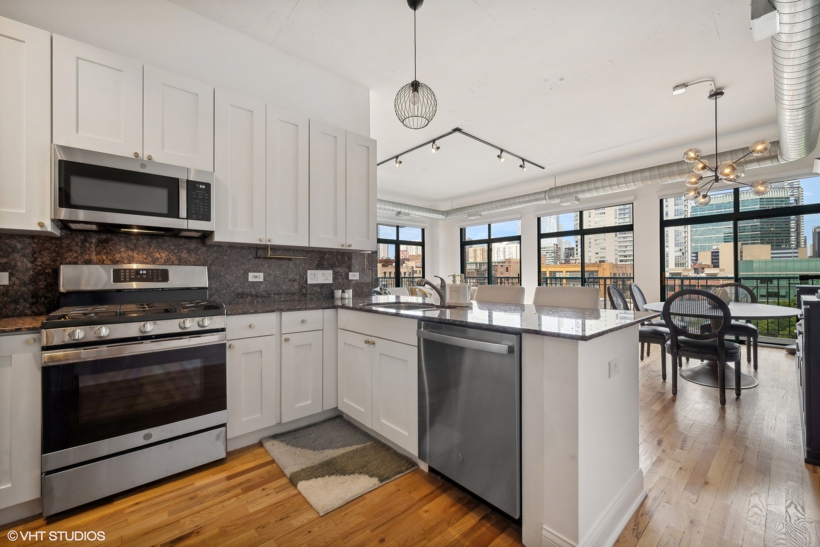 910 West Madison Street, Unit 608 Chicago, IL 60607 - Photo 2 of 15 a kitchen with stainless steel appliances granite countertop a stove and cabinets