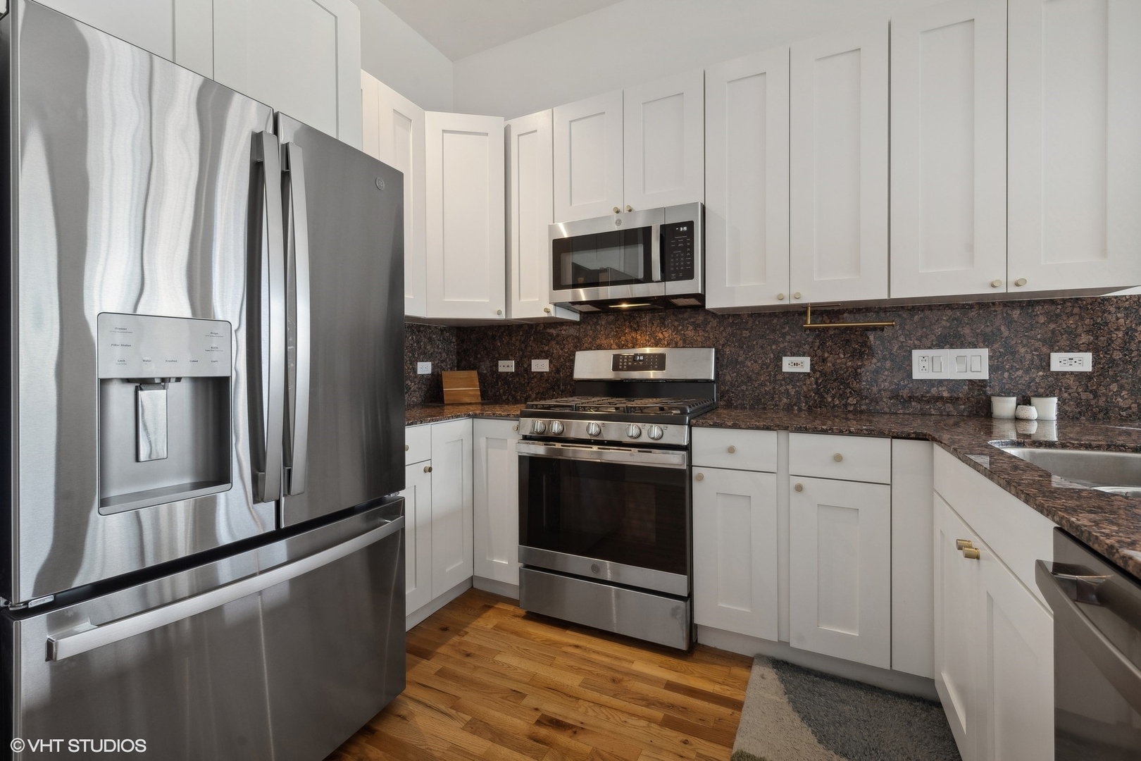 910 West Madison Street, Unit 608 Chicago, IL 60607 - Photo 3 of 15 a kitchen with stainless steel appliances granite countertop a refrigerator stove and sink