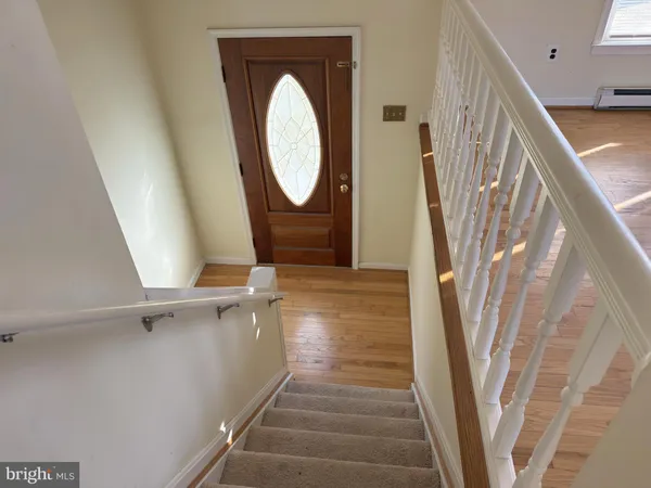 a view of a hallway with wooden floor and entryway
