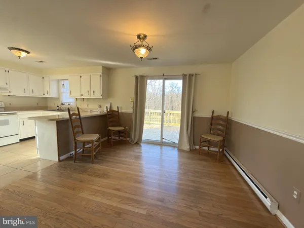 a view of a livingroom with furniture and a workspace