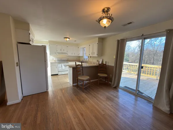 a work room with wooden floor and furniture