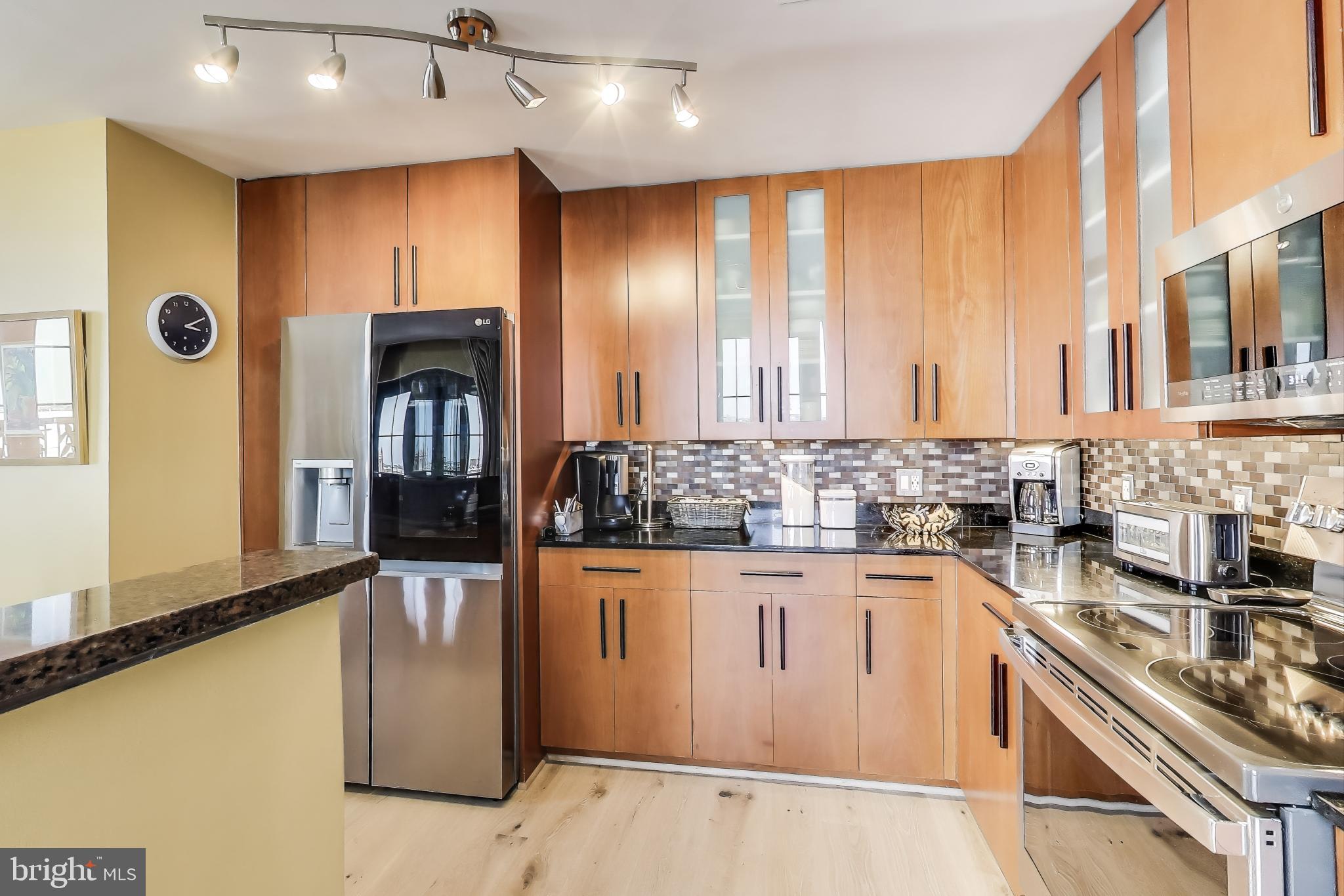 910 M Street Northwest, Unit 1022 Washington, DC 20001 - Photo 13 of 64 a kitchen with stainless steel appliances granite countertop a sink and cabinets