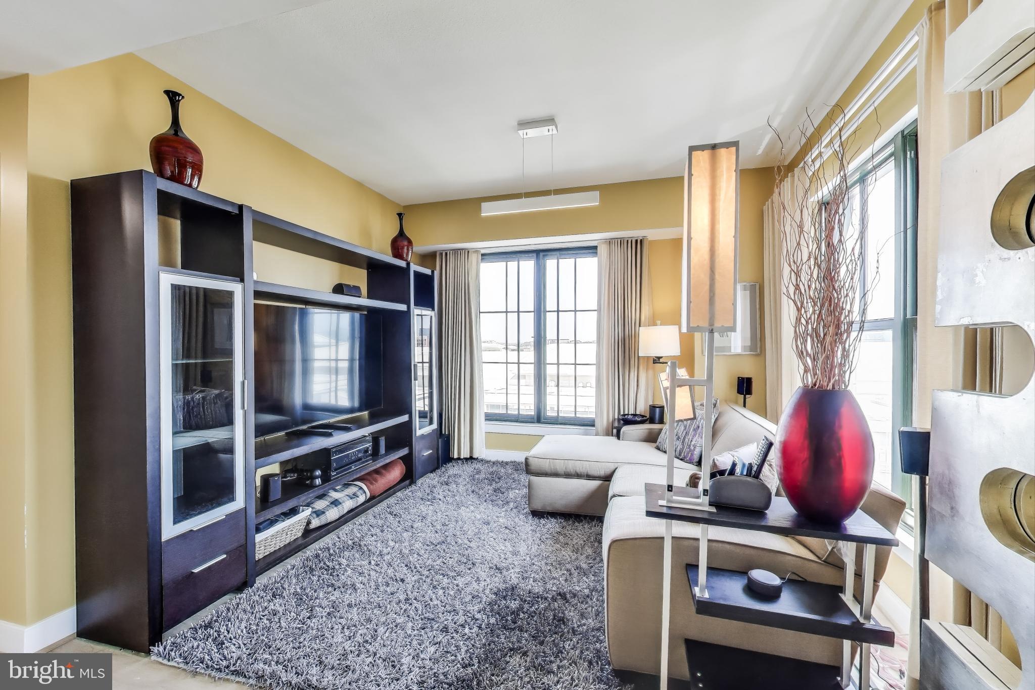 910 M Street Northwest, Unit 1022 Washington, DC 20001 - Photo 16 of 64 a living room with furniture windows and a flat screen tv