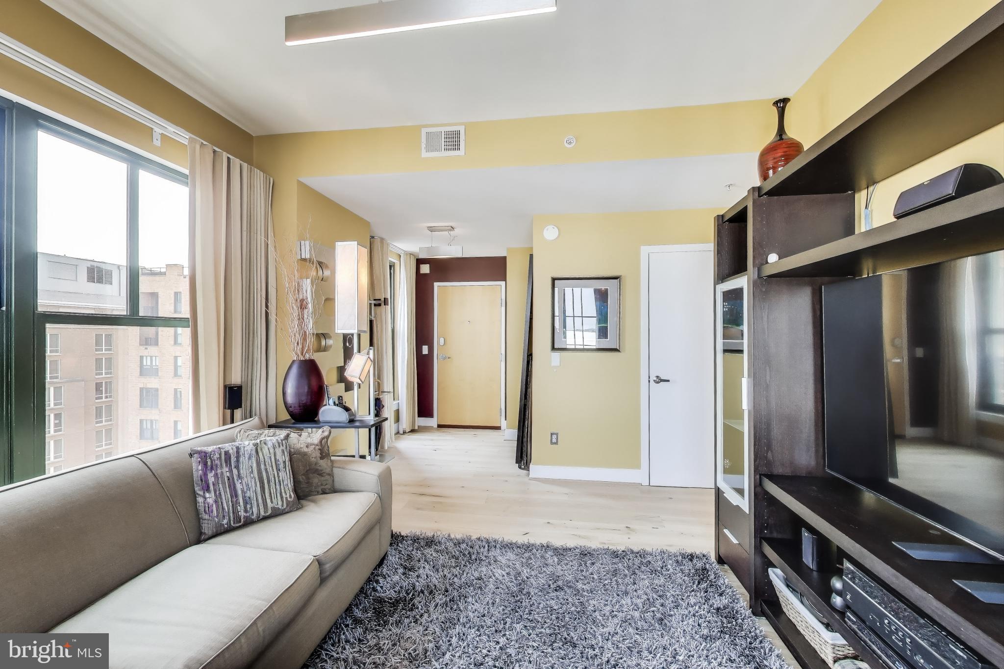 910 M Street Northwest, Unit 1022 Washington, DC 20001 - Photo 18 of 64 a living room with furniture and a window