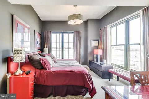 a bedroom with a large bed and a window