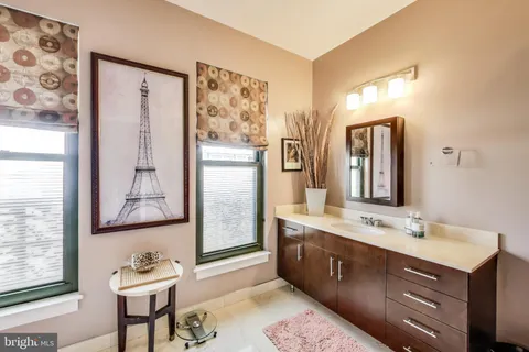 a bathroom with a double vanity sink and a mirror