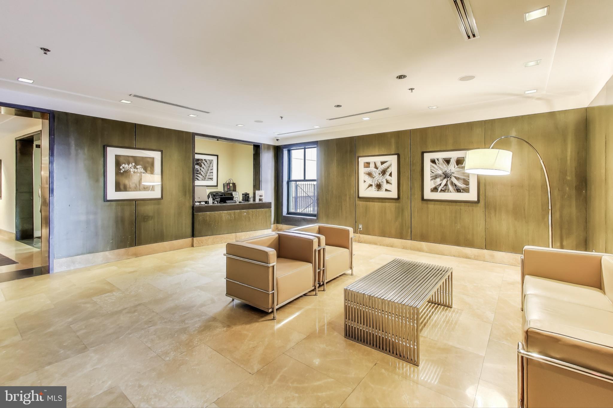 910 M Street Northwest, Unit 1022 Washington, DC 20001 - Photo 37 of 64 a living room with furniture and paintings on the wall