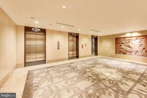 a view of roof deck with dining table and chairs with wooden floor