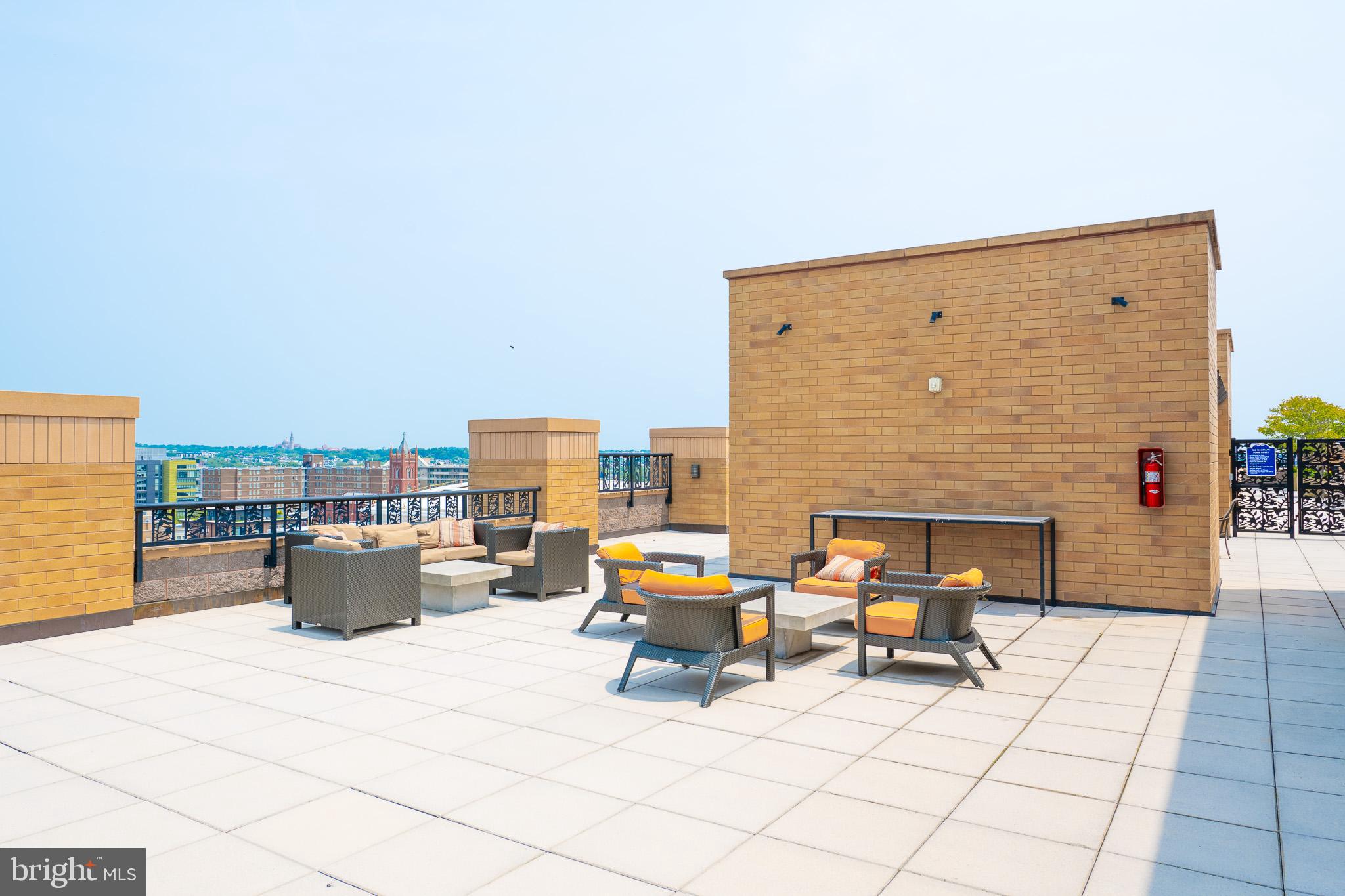 910 M Street Northwest, Unit 1022 Washington, DC 20001 - Photo 52 of 64 a living room with patio furniture and a fireplace
