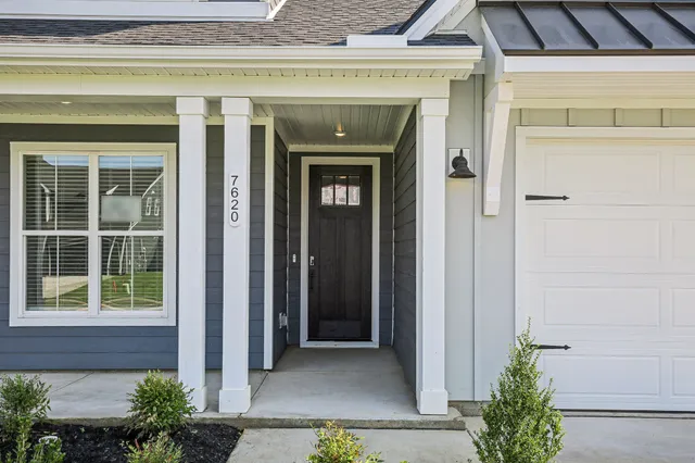 an empty room with windows and fireplace