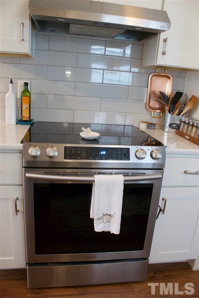 4436 Archibald Way Raleigh, NC 27616 - Photo 13 of 25 a stove top oven sitting inside of a kitchen