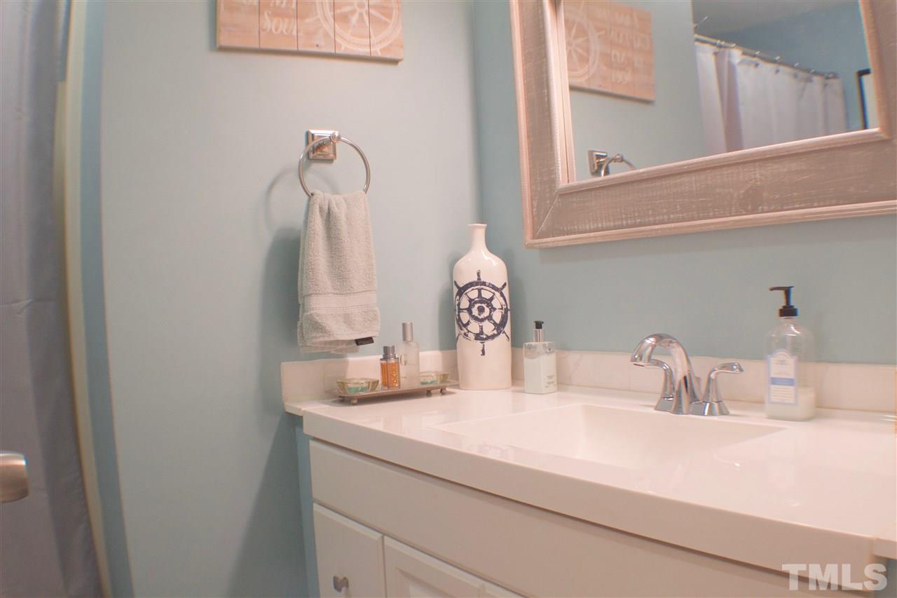 4436 Archibald Way Raleigh, NC 27616 - Photo 14 of 25 a bathroom with a sink and a mirror