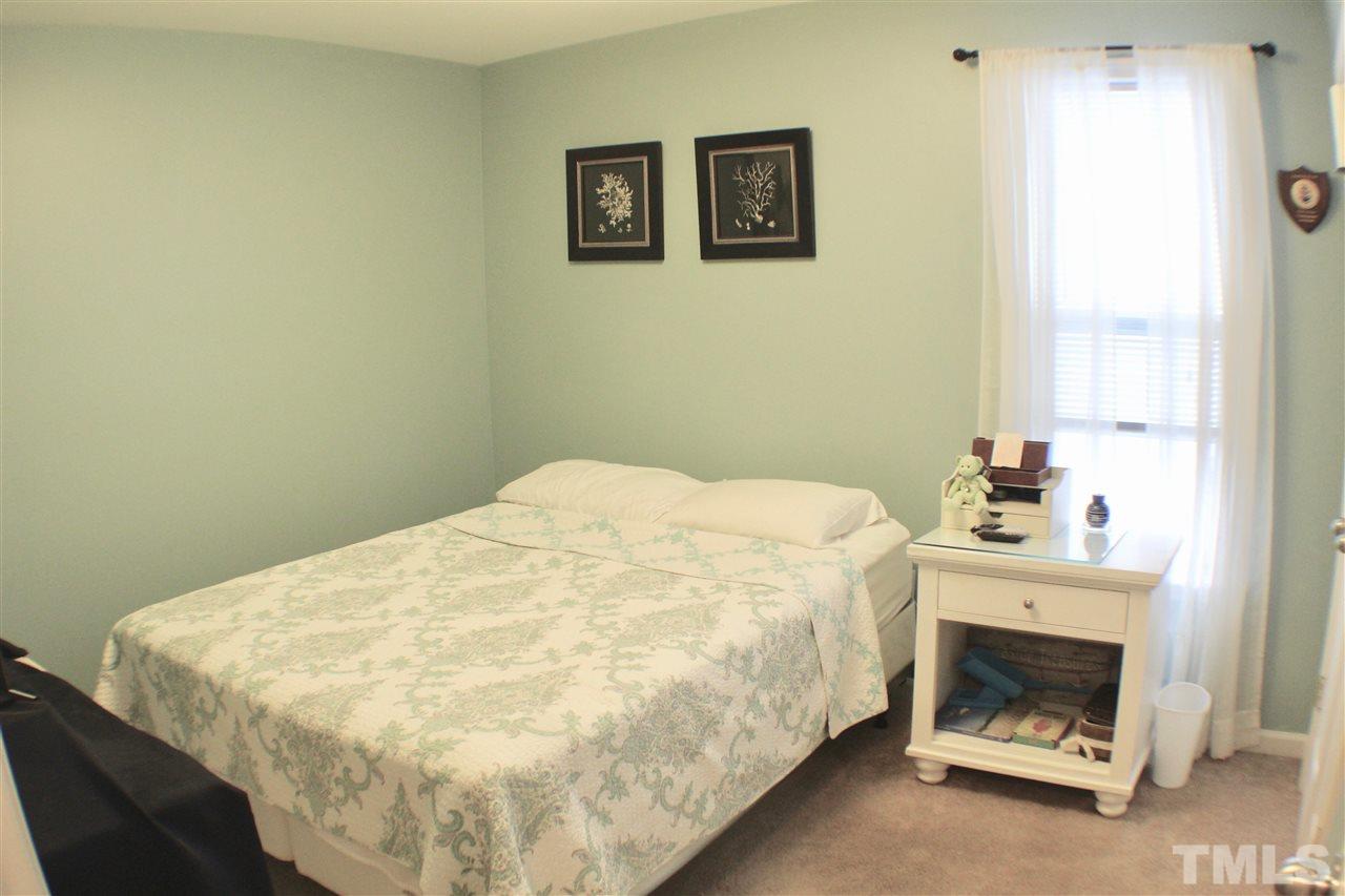 4436 Archibald Way Raleigh, NC 27616 - Photo 16 of 25 a bed sitting in a bedroom next to a window