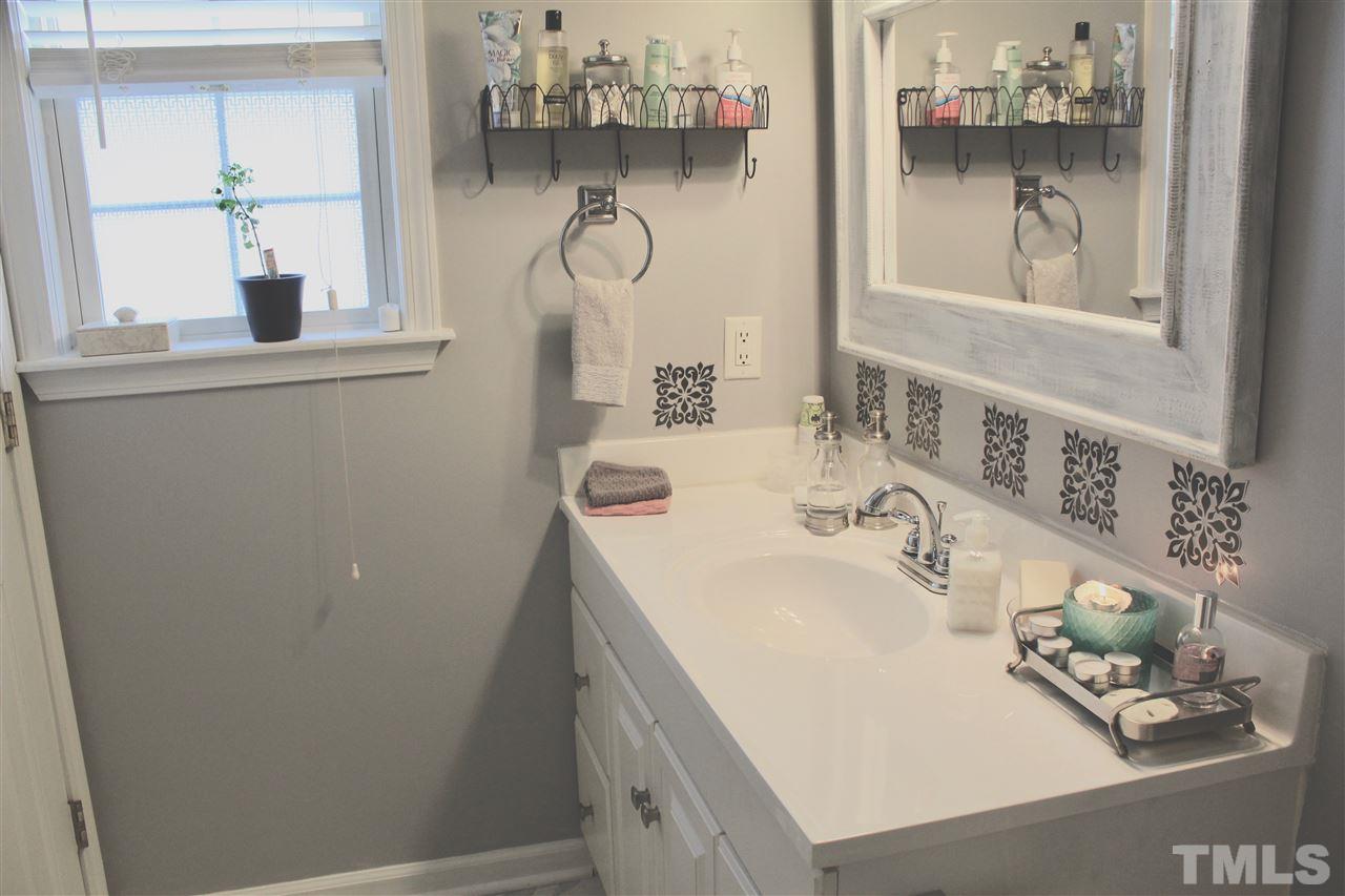 4436 Archibald Way Raleigh, NC 27616 - Photo 20 of 25 a bathroom with a sink and a mirror