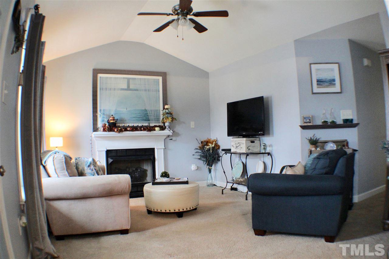 4436 Archibald Way Raleigh, NC 27616 - Photo 3 of 25 a living room with furniture and a flat screen tv