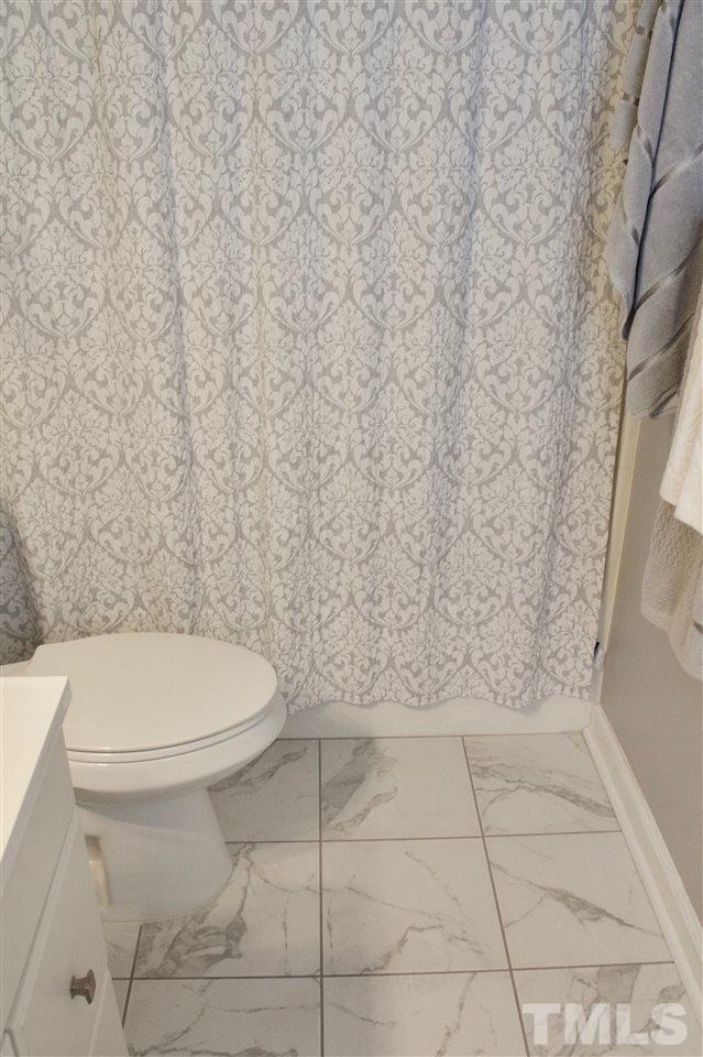 4436 Archibald Way Raleigh, NC 27616 - Photo 22 of 25 a bathroom with a toilet and a shower