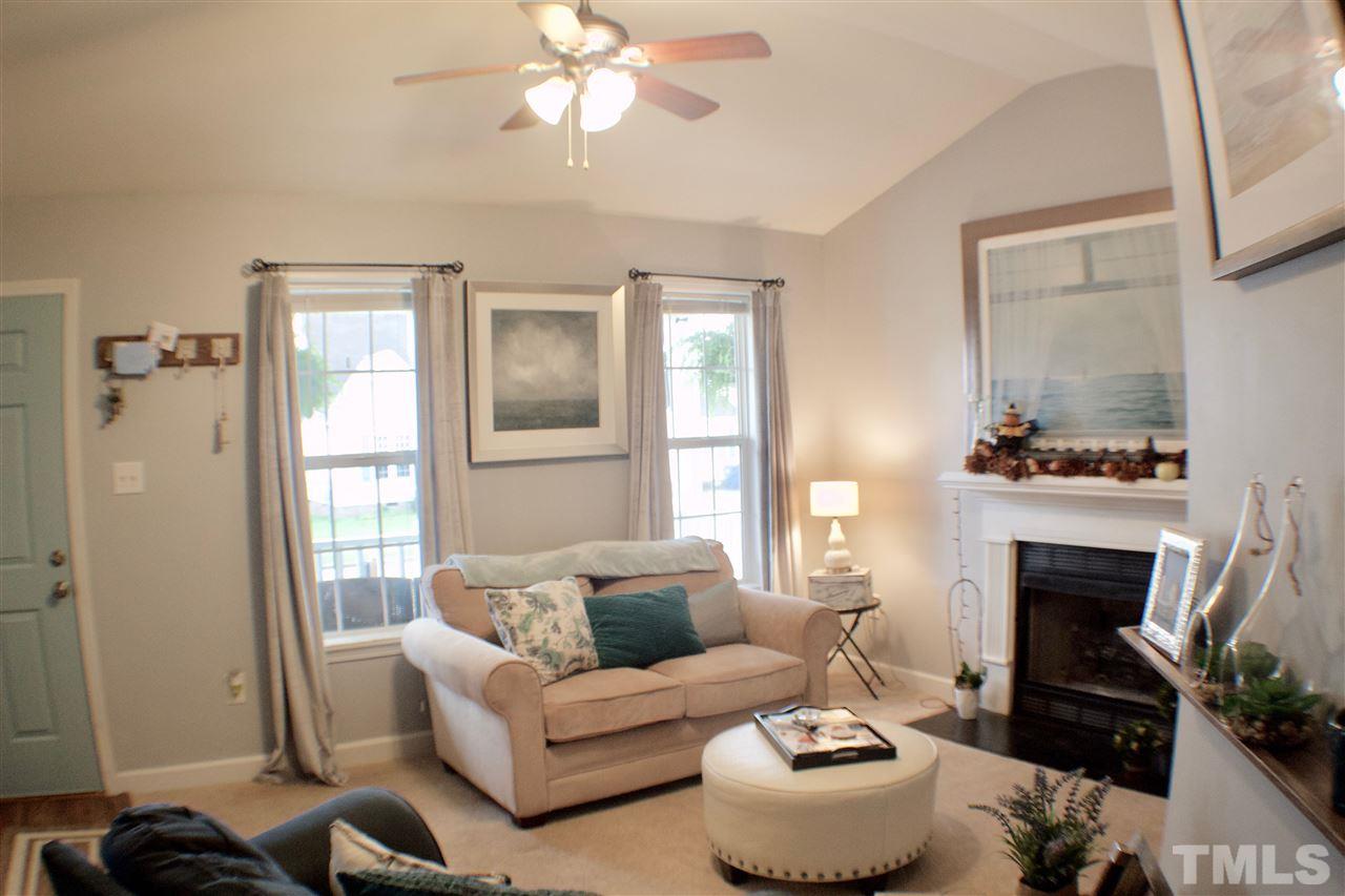 4436 Archibald Way Raleigh, NC 27616 - Photo 4 of 25 a living room with furniture and a fireplace