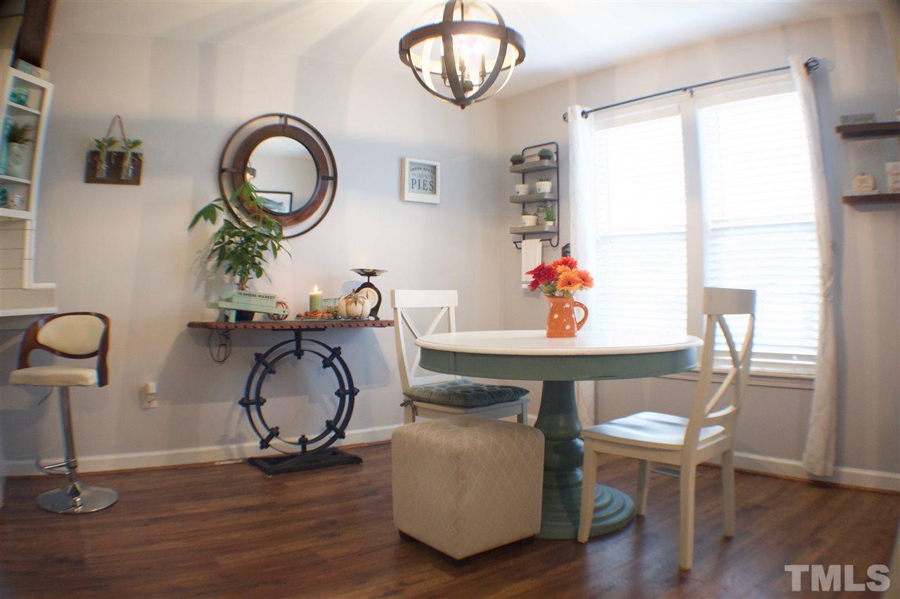 4436 Archibald Way Raleigh, NC 27616 - Photo 6 of 25 a view of a dining room with furniture a chandelier and wooden floor
