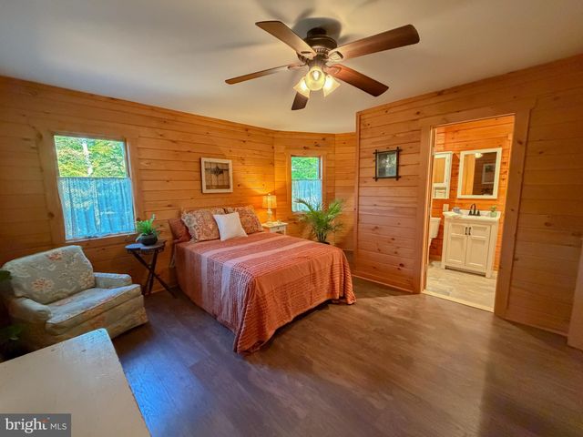 a spacious bedroom with a bed a couch and a walk in closet
