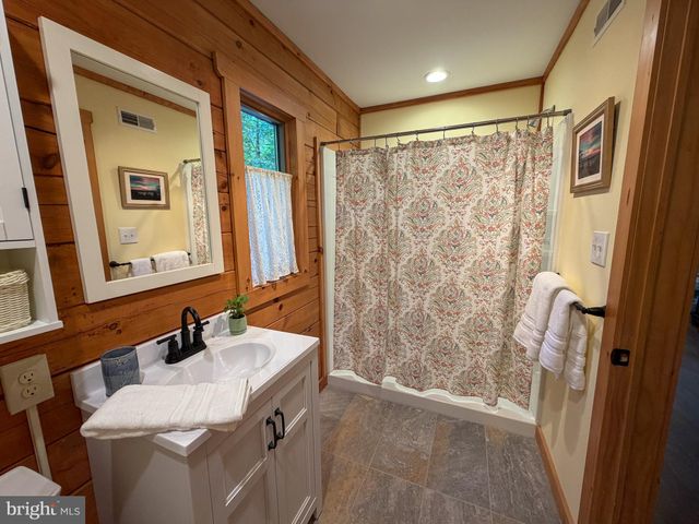 a bathroom with a double vanity sink and mirror