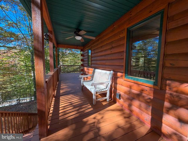 a view of a chairs and table in the balcony
