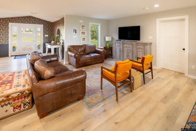 a living room with furniture and a flat screen tv