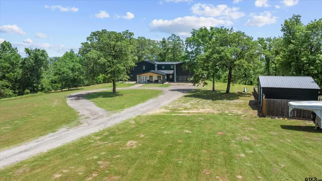a view of a backyard with sitting area