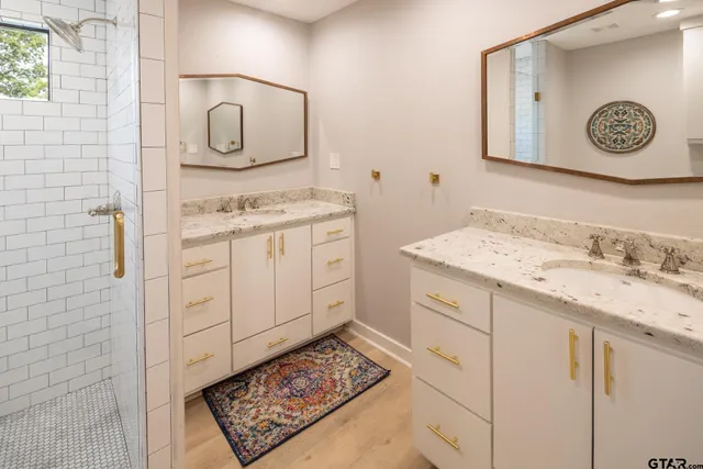 a bathroom with a sink a vanity and a mirror