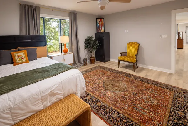 a bedroom with a bed and a window