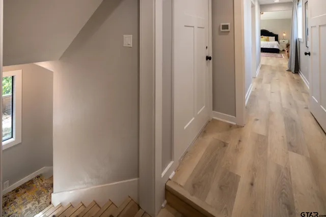 a view of bedroom with a bed and wooden floor