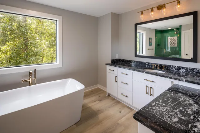 a spacious bathroom with a bathtub and a sink
