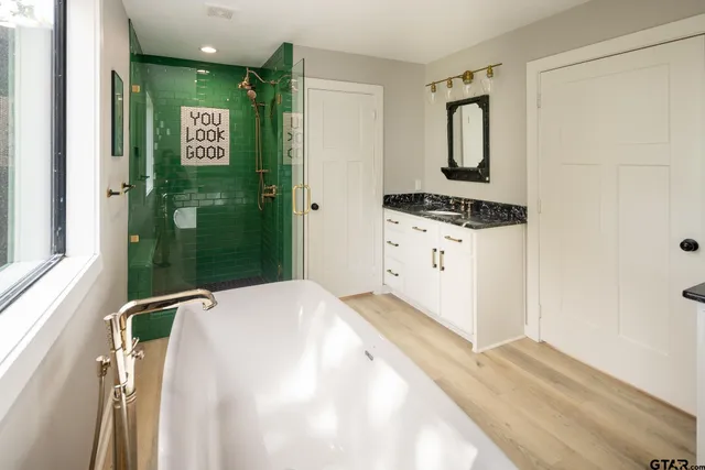 a bedroom with a refrigerator and a sink