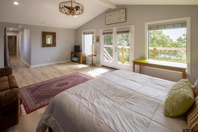 a bedroom with a bed and a large window