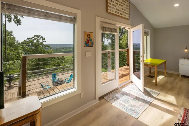 a view of a room with a floor to ceiling window and an outdoor view